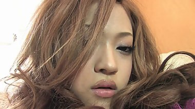 Saucy vixen in fishnet stockings fills her pussy with a black dildo