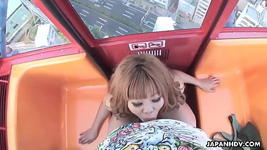 Asian babe sucking a dick on a ferris wheel