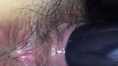 Hairy Japanese girl with a toy in her pussy