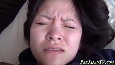 Asian babe pees in vase