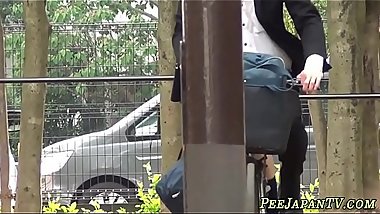 Asian teens piss outdoors