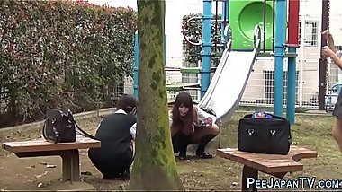 Playful teens pee outside