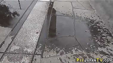 Asian in heels urinates