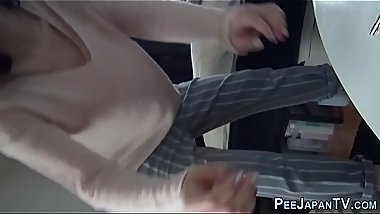 Asian teen peeing in cup