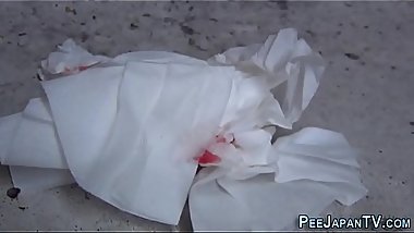 Asian slut squats to pee