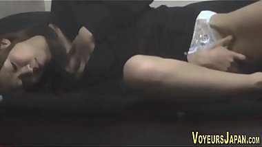 Japanese babe rubs pussy